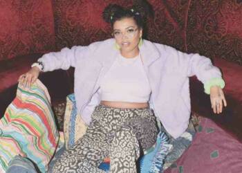 Sarah Barrable Tishauer sitting on sofa