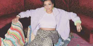 Sarah Barrable Tishauer sitting on sofa