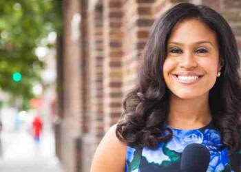 Meagan Fitzgerald reporting in a field