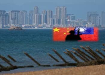 Anti-landing barricades are pictured on an a beach on Kinmen, Taiwan, on Feb. 21. The Chinese city of Xiamen is seen in the background. © Reuters