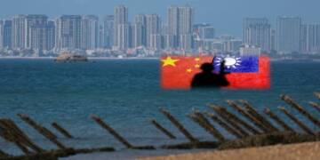 Anti-landing barricades are pictured on an a beach on Kinmen, Taiwan, on Feb. 21. The Chinese city of Xiamen is seen in the background. © Reuters