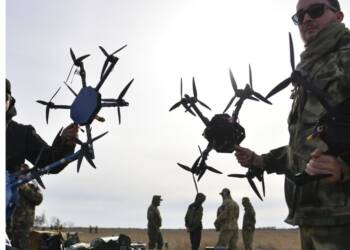 A Ukrainian FPV combat drone in flight, equipped with an explosive payload—part of the country's game-changing drone warfare strategy reshaping modern military tactics.