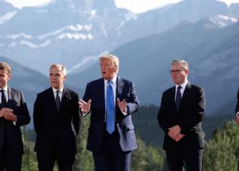 French President Emmanuel Macron, from left, Canada's Prime Minister Mark Carney, U.S. President Donald Trump, Britain's Prime Minister Keir Starmer, and German Chancellor Friedrich Merz prepare for a family photo during the G7 Summit, in Kananaskis, Alberta, Monday, June 16, 2025. (Suzanne Plunkett/Pool Photo via AP)