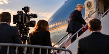 Donald Trump boards a presidential aircraft as journalists and television cameras watch from behind a barrier on the tarmac.CNN