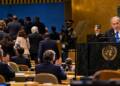 Israeli Prime Minister Benjamin Netanyahu speaks at the UN General Assembly as delegates walk out of the chamber, with some remaining delegates applauding.