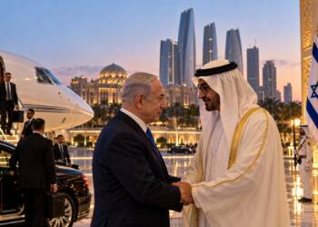 Israeli Prime Minister Benjamin Netanyahu meets UAE President Sheikh Mohamed bin Zayed in Abu Dhabi, with a private jet, security officials and Israeli and UAE flags visible in the background.
