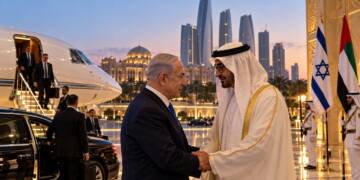Israeli Prime Minister Benjamin Netanyahu meets UAE President Sheikh Mohamed bin Zayed in Abu Dhabi, with a private jet, security officials and Israeli and UAE flags visible in the background.