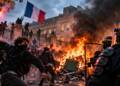France student protests erupt outside a French school as demonstrators confront riot police amid flames, smoke and street unrest.